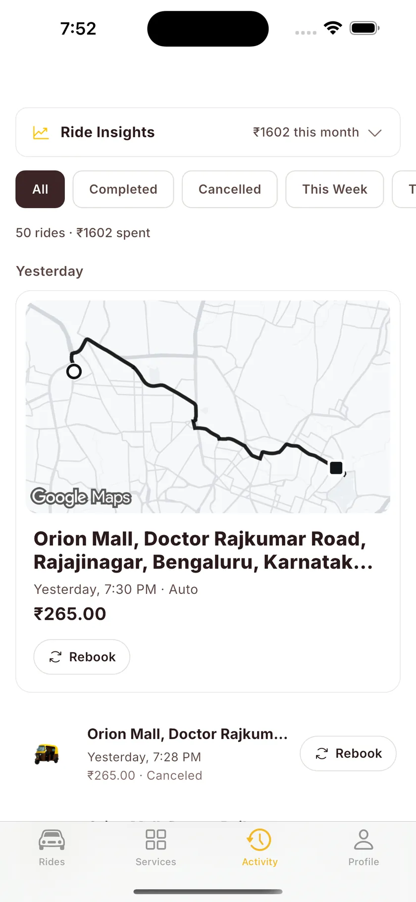 Activity tab with Ride Insights: ₹1,602 spent this month across 50 rides, each trip card carrying a route map and a Rebook button.