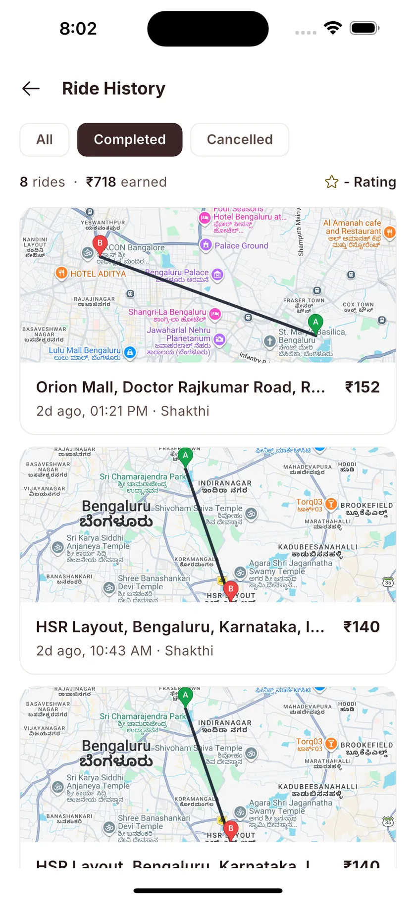 Ride history: 8 rides and ₹718 earned, each trip card with its route map.